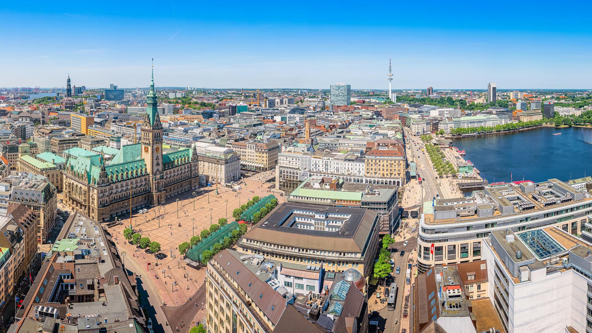 Beautiful aerial view of historic city center of hanseatic Hamburg with famous town hall at market square and ancient harbour district in the background on a sunny day with blue sky in summer, Germany; Shutterstock ID 1722098242; purchase_order: Julia Romero